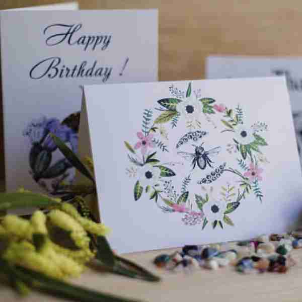 Blank card with bee in a floral wreath