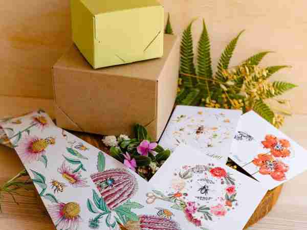 Nina's Bees gift wrapping with botanical belly wrap featuring bees and clover, accompanied by a floral card
