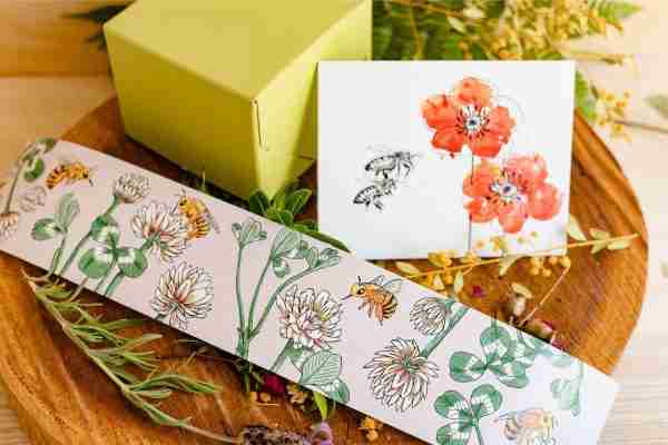 Nina's Bees gift wrapping with botanical belly wrap featuring bees and clover, accompanied by a floral card