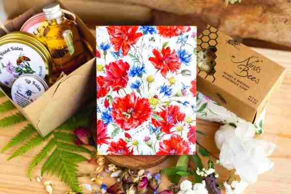 Card covered with red poppies, blue cornflowers, and daisies