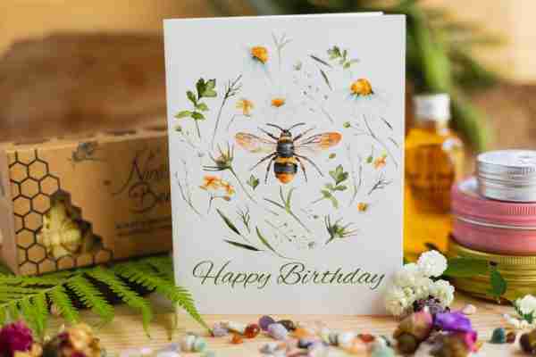 Birthday card with bee, wildflowers, and Happy Birthday text