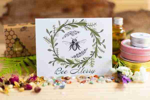 Bee Merry card with bee illustration and green foliage wreath