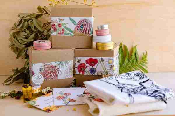 Eco Friendly gift wrapping . The kraft gift boxes with wrapping paper . wrapping paper shows beautiful artwork with flowers and bees