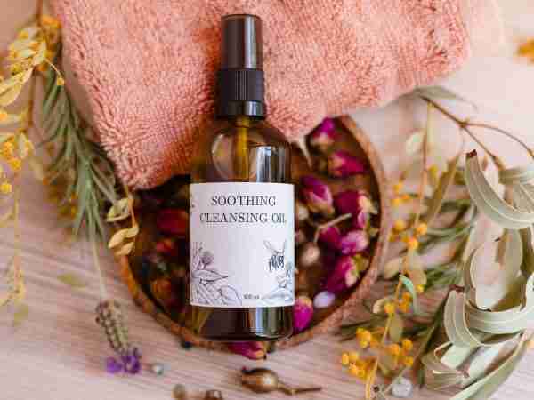 Nina’s Bees Soothing Cleansing Oil bottle with dried flowers and greenery
