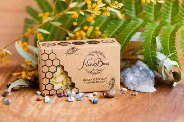 Handmade Honey & Beeswax Soap from Nina’s Bees in eco-friendly packaging with floral accents
