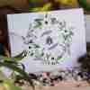 Blank card with bee in a floral wreath