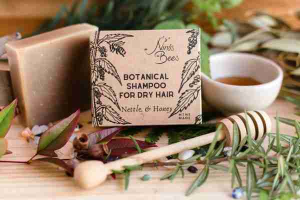 Nina’s Bees Nettle & Honey Shampoo Bar – solid green botanical shampoo bar on kraft packaging with bee artwork