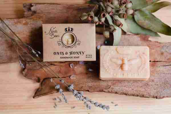 Box of Nina’s Bees Oats & Honey Handmade Soap displayed on a wooden surface with dried botanicals, crystals, and natural elements.