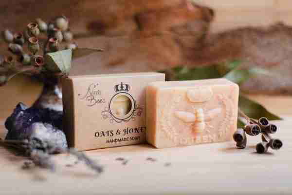 Box of Nina’s Bees Oats & Honey Handmade Soap displayed on a wooden surface with dried botanicals, crystals, and natural elements.