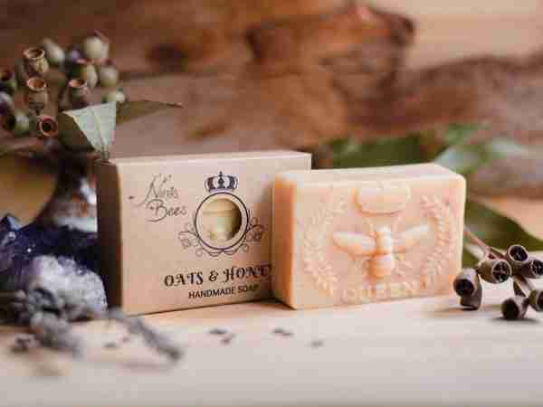 Box of Nina’s Bees Oats & Honey Handmade Soap displayed on a wooden surface with dried botanicals, crystals, and natural elements.